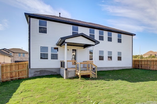 rear view of property with a lawn