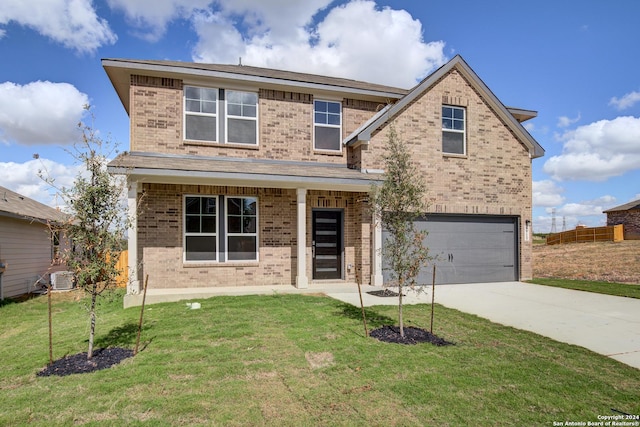 view of front of house featuring covered porch, cooling unit, a garage, and a front yard