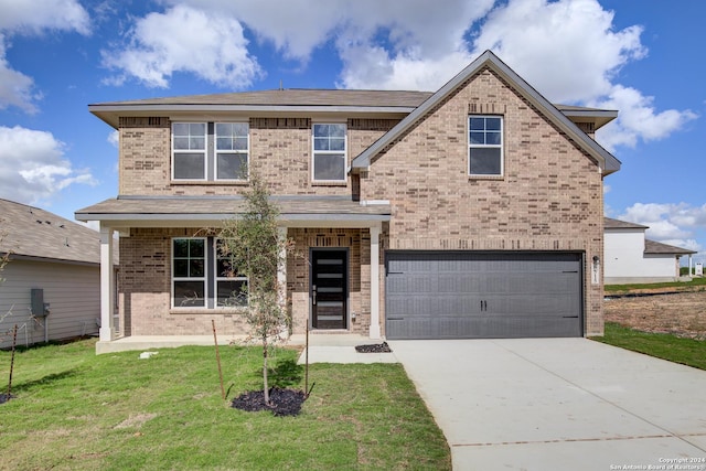 view of front facade featuring a garage and a front lawn