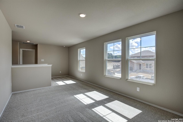 carpeted empty room with recessed lighting, visible vents, and baseboards