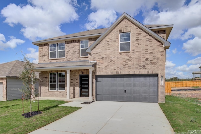 view of front of home featuring a front yard and a garage