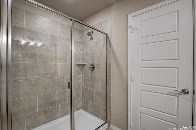 full bath featuring a shower stall