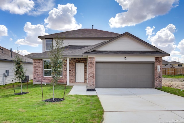 view of front of house with a front lawn and a garage