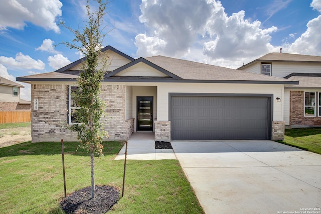 view of front of property featuring a garage and a front yard