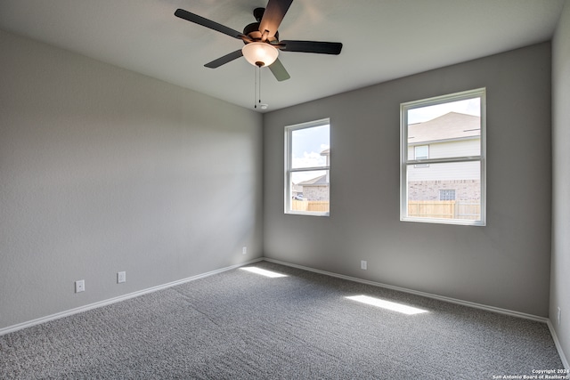 unfurnished room featuring ceiling fan and carpet