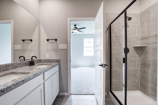 bathroom featuring vanity, an enclosed shower, and ceiling fan