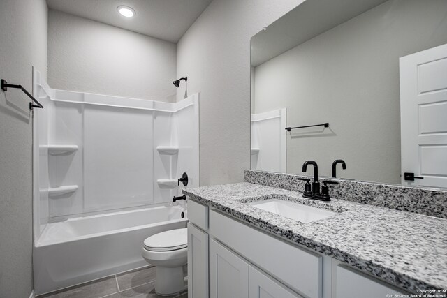 full bathroom with vanity, washtub / shower combination, and toilet