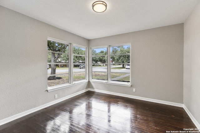 unfurnished room featuring dark hardwood / wood-style floors