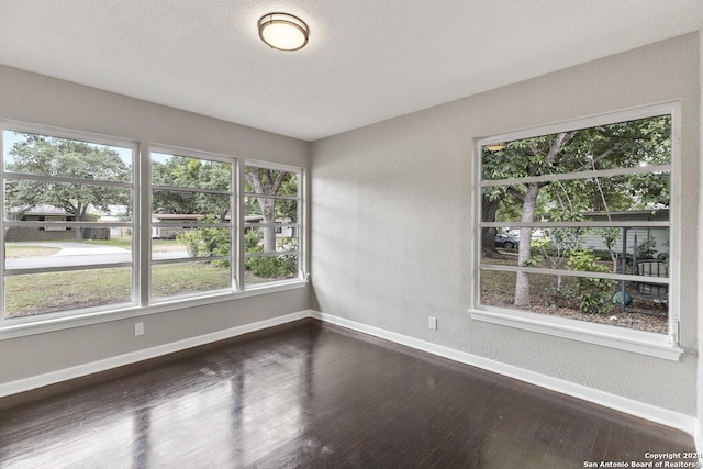 empty room with dark wood-type flooring