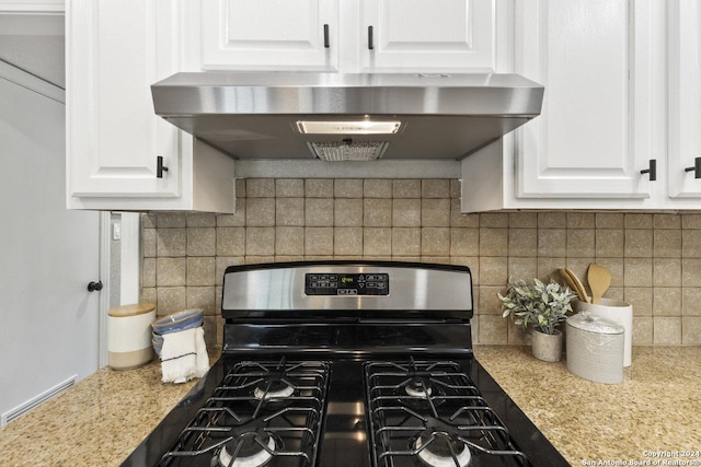 kitchen featuring white cabinets, stainless steel gas stove, decorative backsplash, and exhaust hood