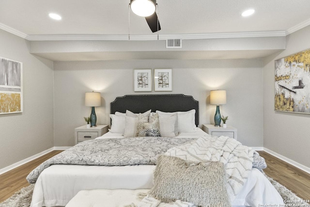 bedroom featuring hardwood / wood-style flooring, ceiling fan, and ornamental molding