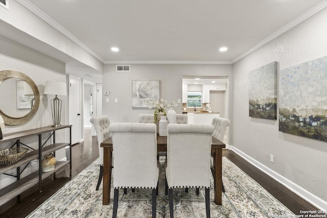 dining space with dark wood-type flooring and ornamental molding