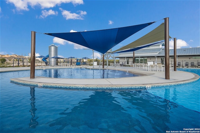 view of swimming pool with a patio area