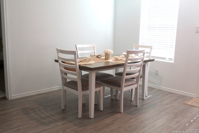 dining space featuring dark hardwood / wood-style floors