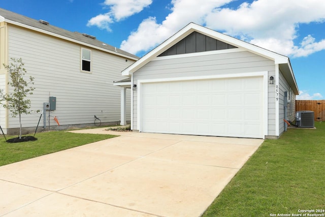 garage with a lawn and central AC