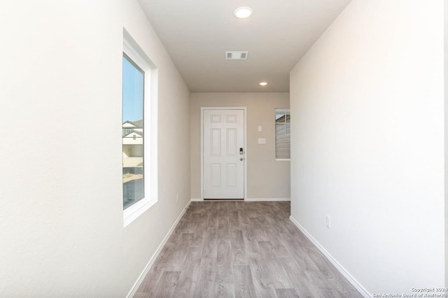 hallway with light wood-type flooring