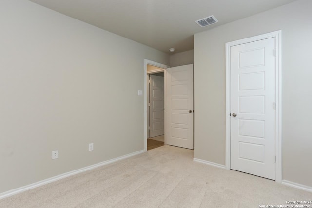 unfurnished bedroom with light colored carpet