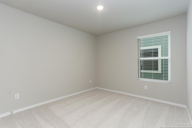 unfurnished room with light carpet