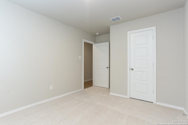 unfurnished bedroom with light carpet