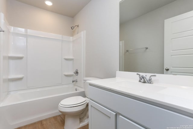 full bathroom featuring wood-type flooring, vanity, toilet, and shower / washtub combination