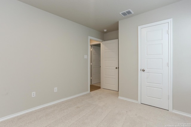 unfurnished bedroom featuring light colored carpet