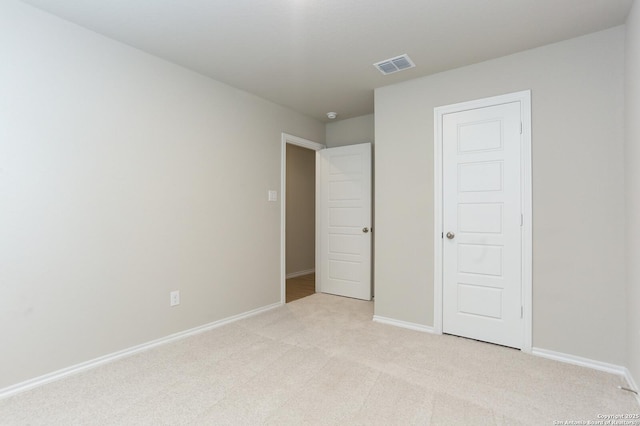 unfurnished bedroom featuring light colored carpet