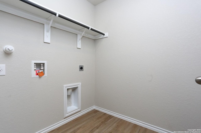 washroom featuring electric dryer hookup, hookup for a washing machine, and hardwood / wood-style flooring