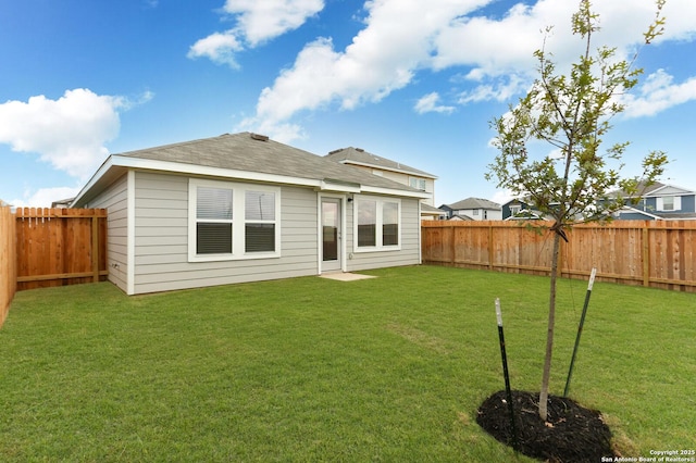 rear view of house featuring a yard