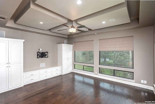 unfurnished bedroom featuring a raised ceiling, ceiling fan, and dark hardwood / wood-style flooring