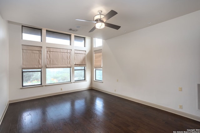 unfurnished room featuring ceiling fan and dark hardwood / wood-style flooring