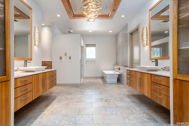 bathroom with vanity, shower with separate bathtub, and a tray ceiling