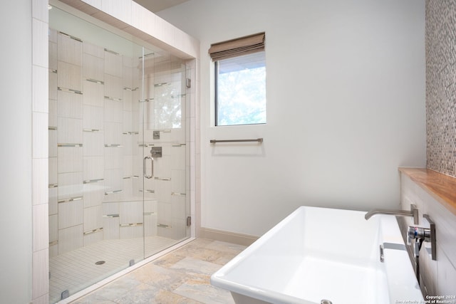 bathroom with sink and independent shower and bath