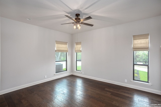 unfurnished room featuring ceiling fan, dark hardwood / wood-style floors, and a healthy amount of sunlight