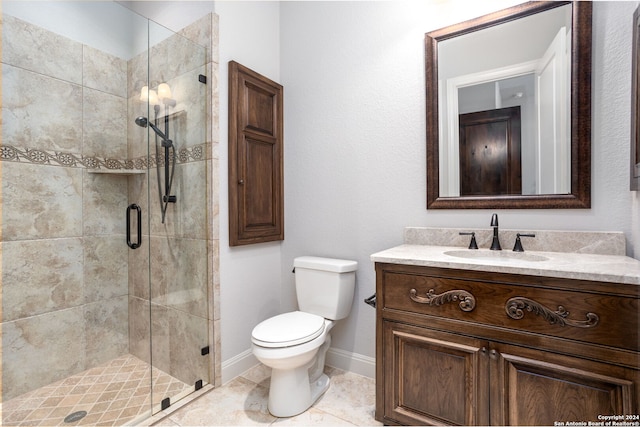 bathroom featuring toilet, tile patterned flooring, walk in shower, and vanity