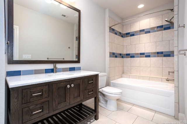 full bathroom featuring vanity, toilet, tile patterned flooring, and tiled shower / bath combo