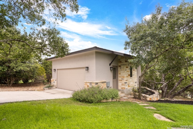 view of front of home featuring a garage and a front lawn