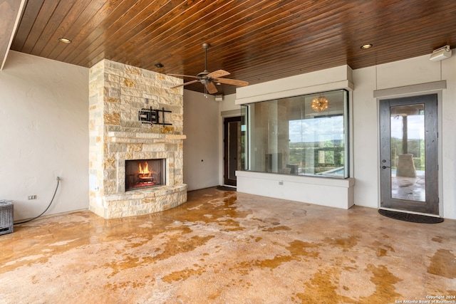 unfurnished living room featuring ceiling fan, wooden ceiling, and a fireplace