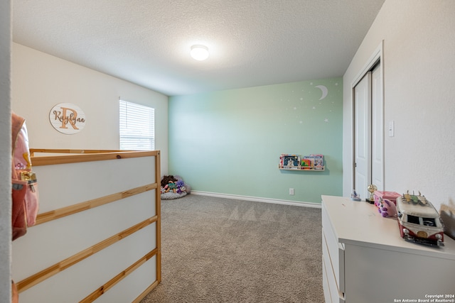 carpeted bedroom with a textured ceiling and a closet