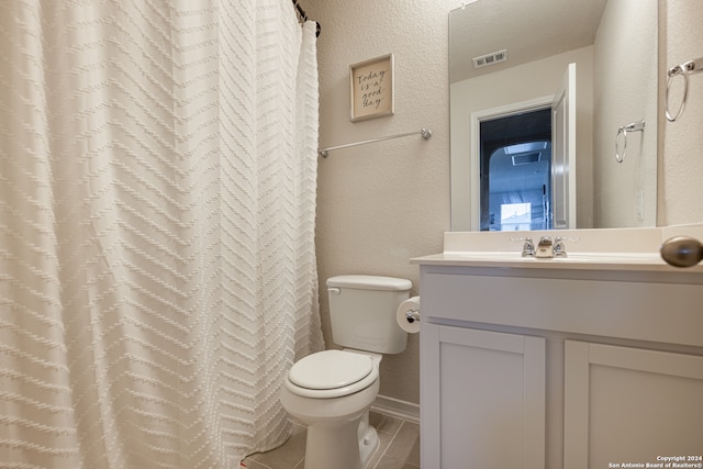 bathroom featuring tile floors, toilet, and vanity