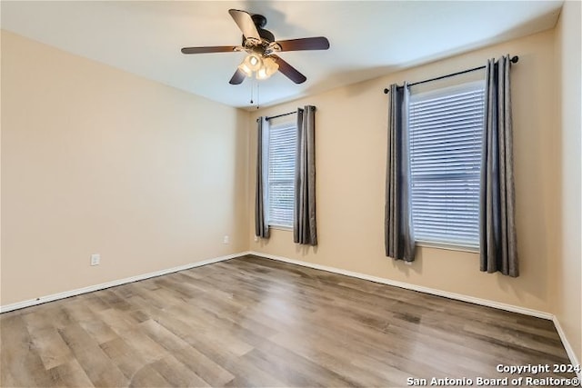 empty room featuring ceiling fan and hardwood / wood-style flooring