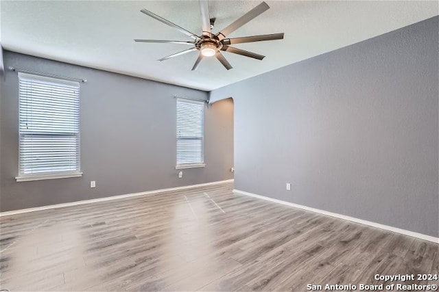 unfurnished room with ceiling fan and light hardwood / wood-style floors