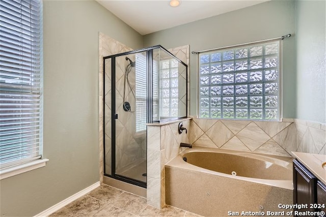 bathroom featuring tile patterned flooring, vanity, and plus walk in shower