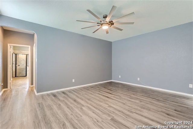 spare room featuring ceiling fan and light hardwood / wood-style floors