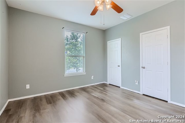 unfurnished bedroom featuring ceiling fan and light hardwood / wood-style floors