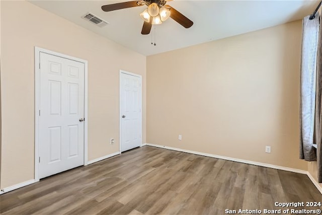 unfurnished bedroom featuring ceiling fan and hardwood / wood-style floors