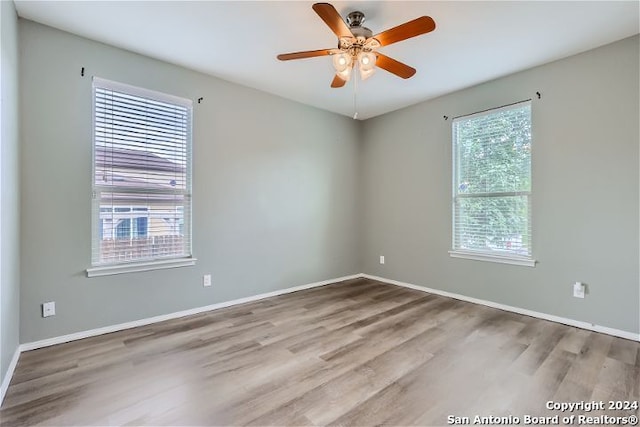 empty room with ceiling fan and light wood-type flooring