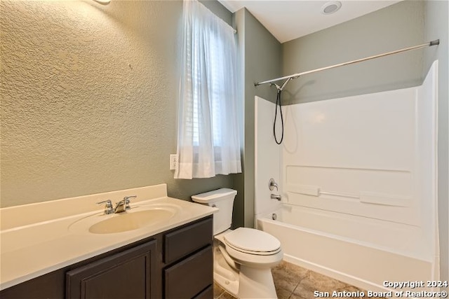 full bathroom with toilet, vanity, and tub / shower combination