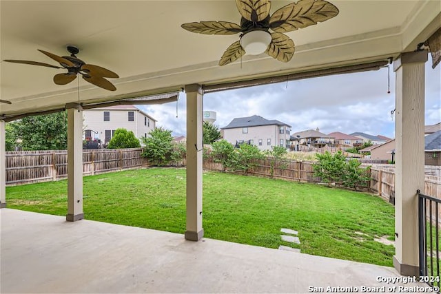 view of yard with ceiling fan and a patio