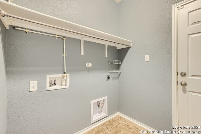 laundry area featuring light tile patterned flooring, hookup for a washing machine, and hookup for an electric dryer