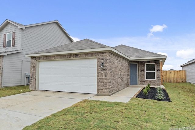 view of front of home with a garage and a front lawn